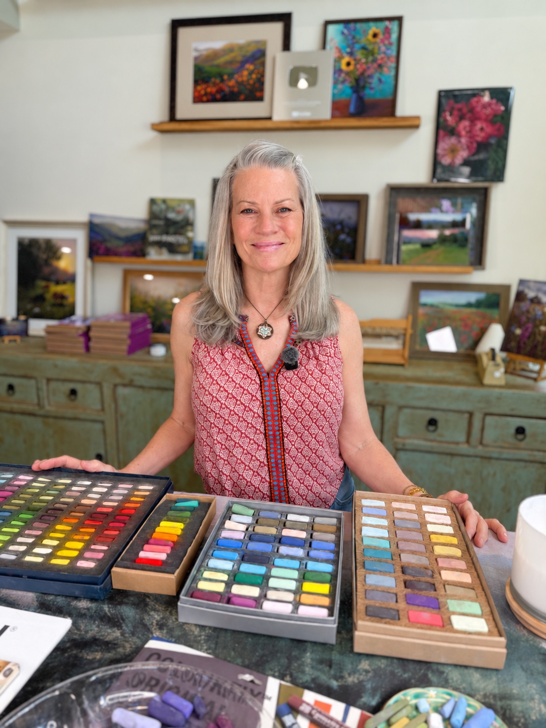 Susan Jenkins in her studio with her soft pastel collection and paintings